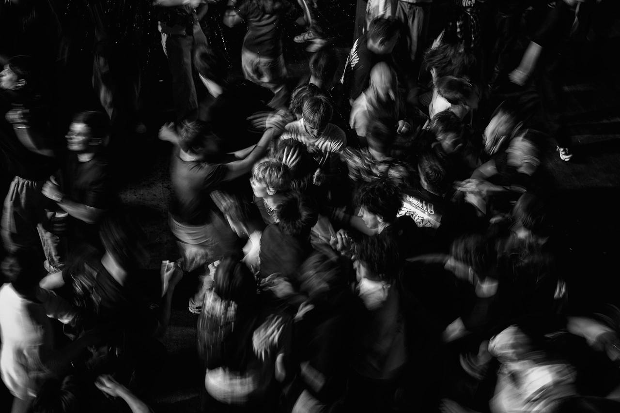Black and white crowd reaching upward