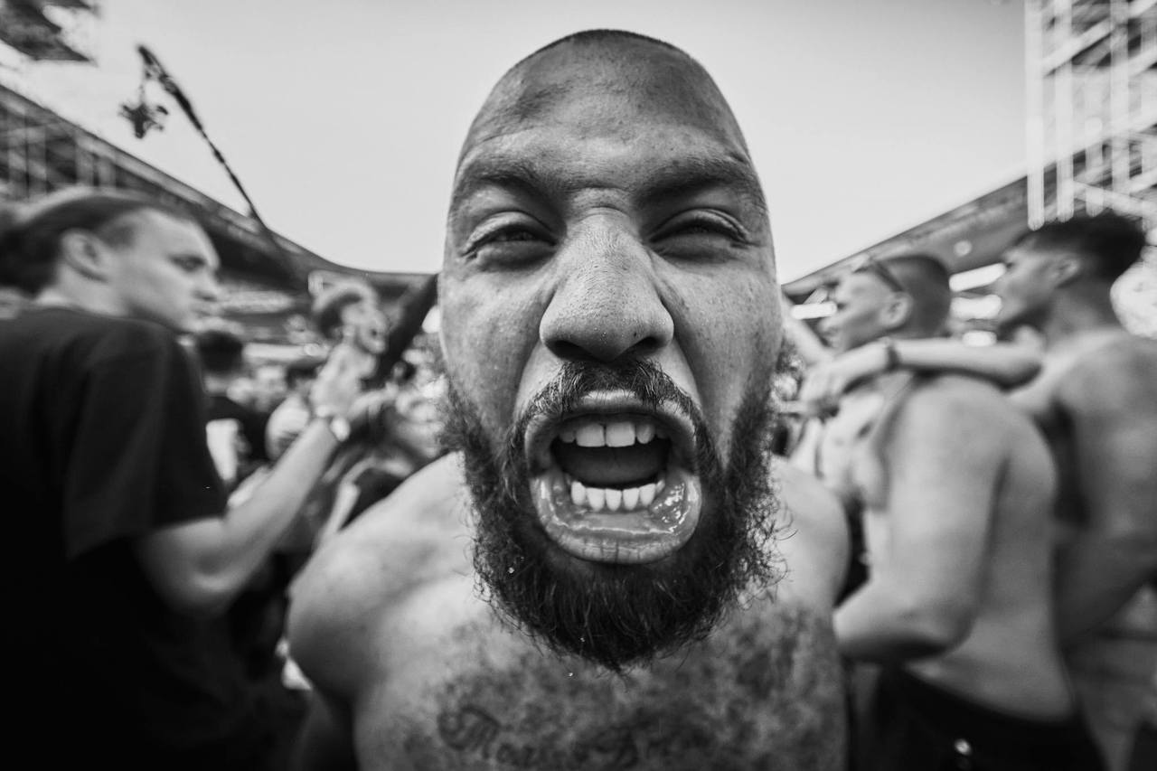 Black and white close-up of a singer shouting with an intense expression