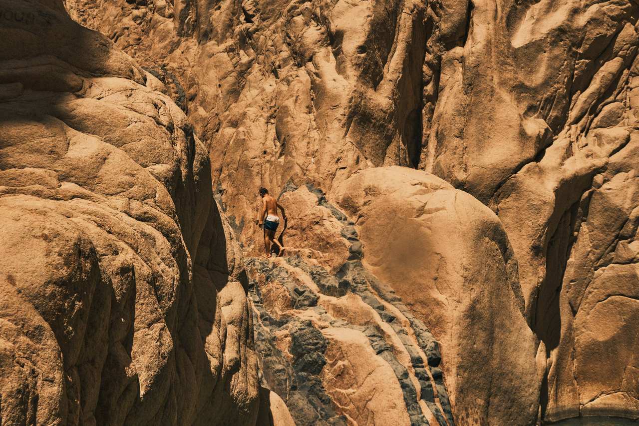 Rock formations carved into a canyon in golden light
