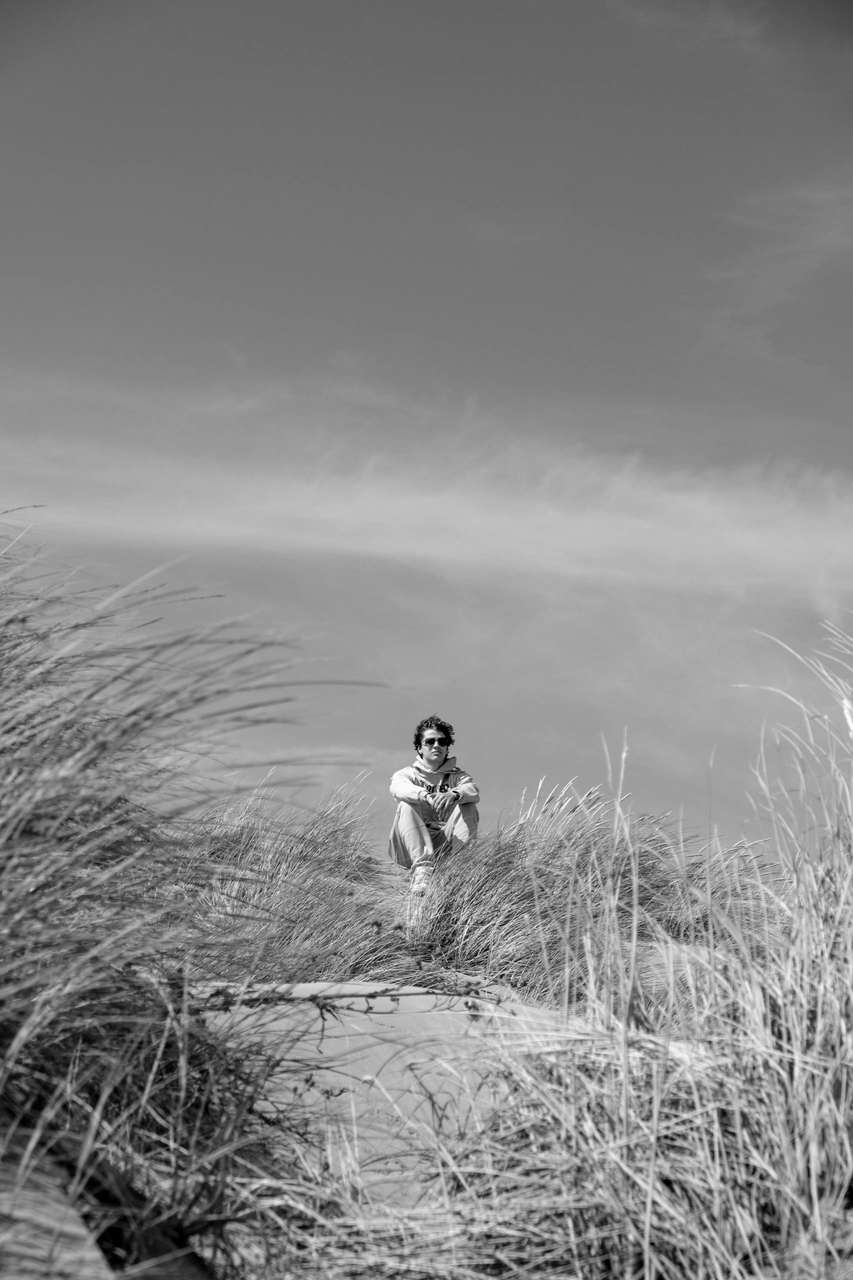 Black and white lone figure in a vast open landscape