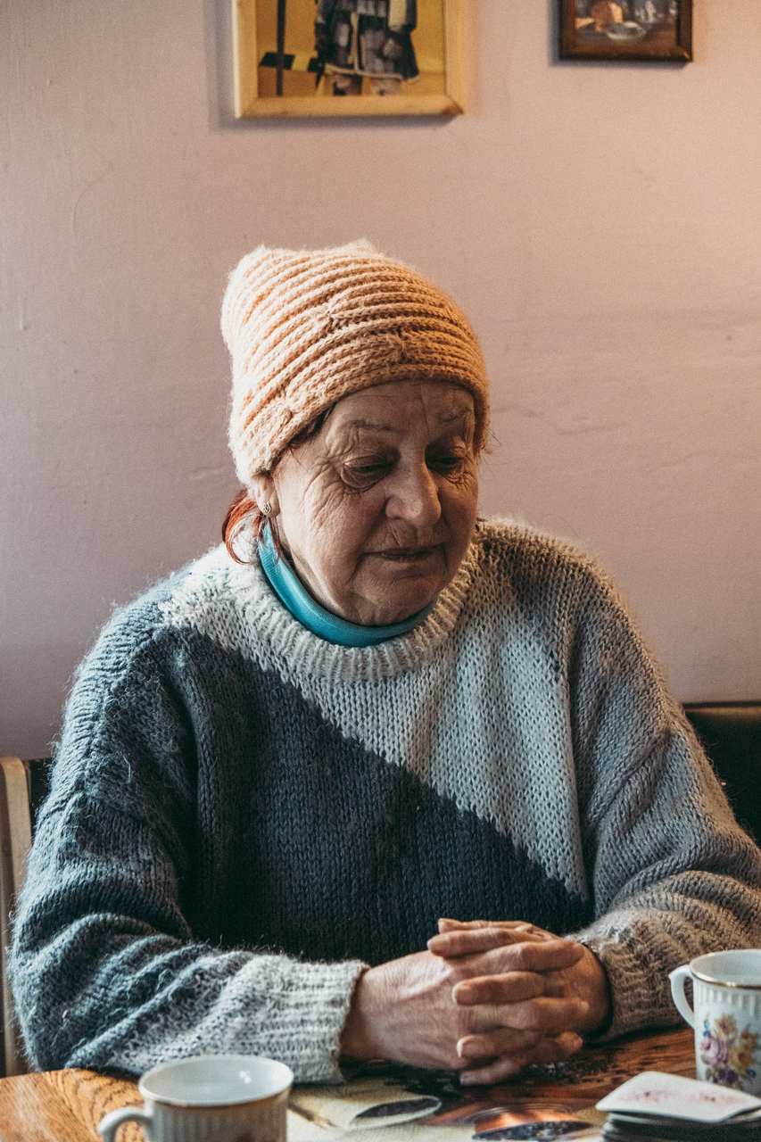 Portrait of a man in a teal sweater and knit cap