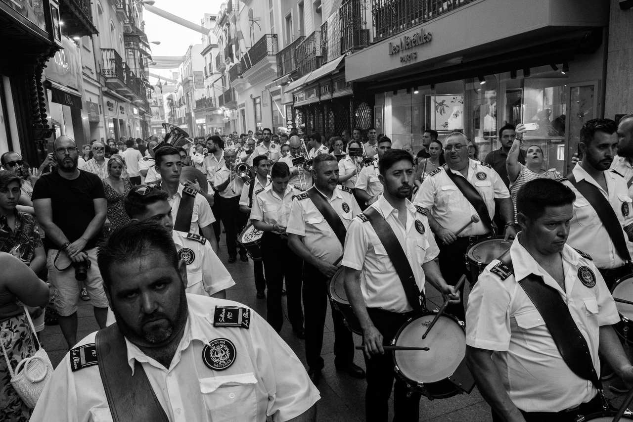 Black and white crowd pressing against a barrier
