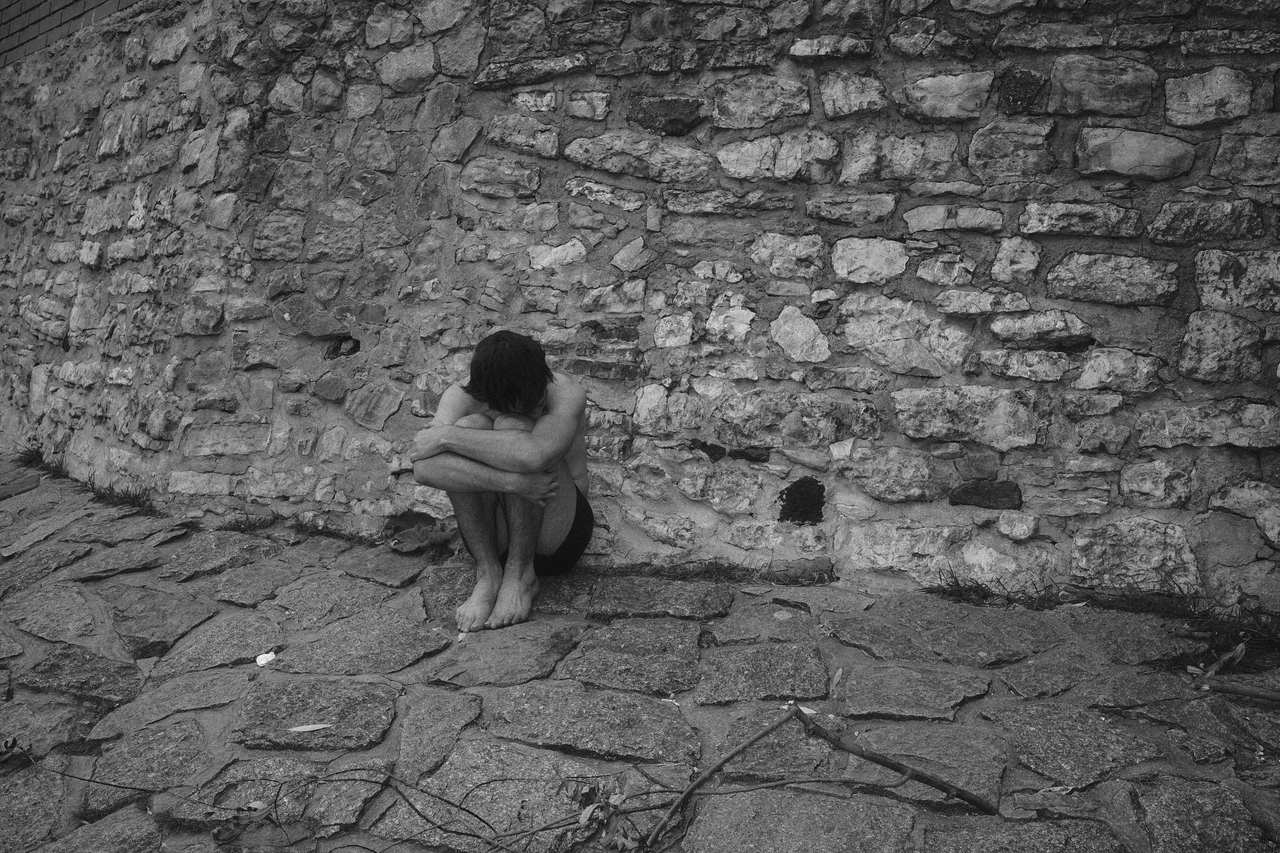 Black and white small figure on an empty stone pavement