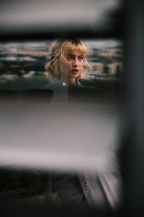 Soft-focus portrait of a woman seen through glass