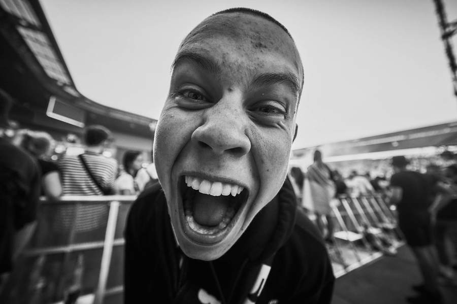 Black and white close-up of a man mid-shout