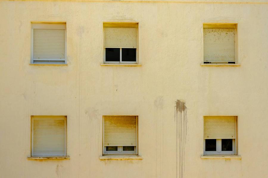 Yellow apartment facade with square windows