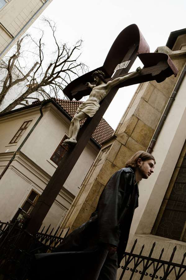 A person scaling a concrete structure against the sky