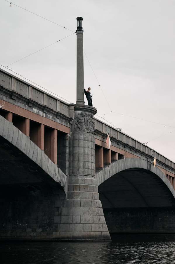 Industrial rooftops and a smokestack in muted tones