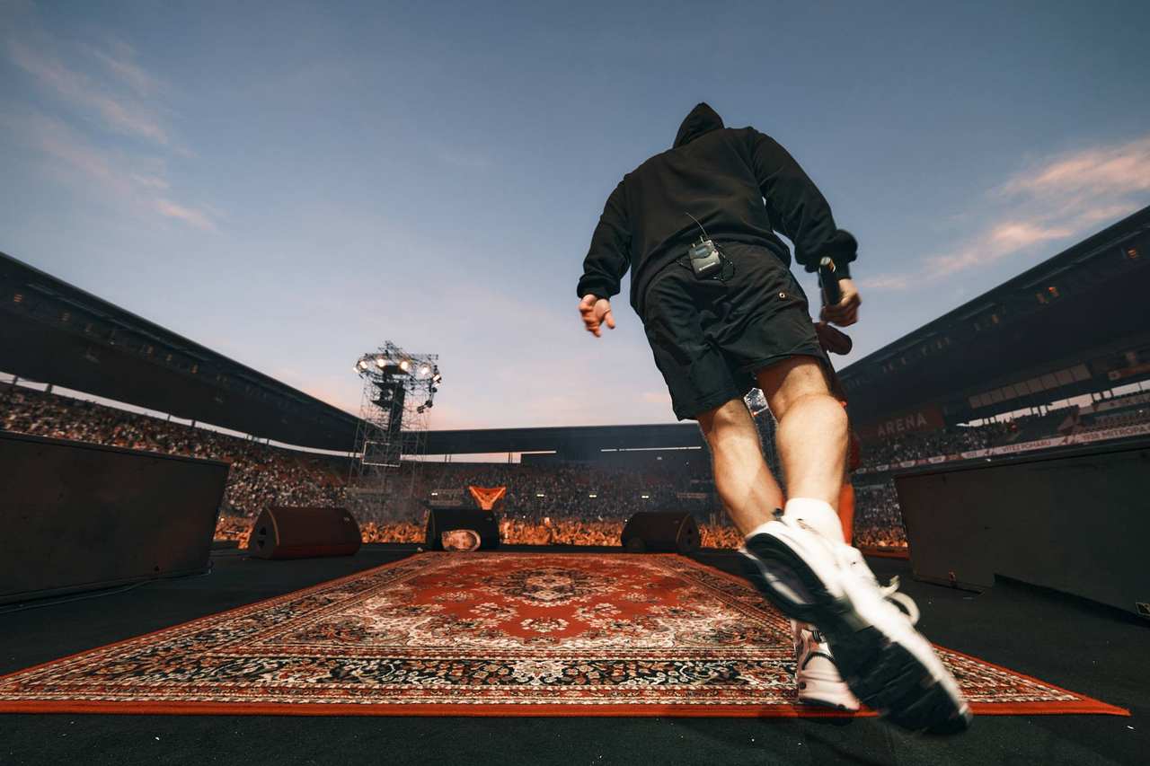 A figure running out onto the stadium carpet, backlit